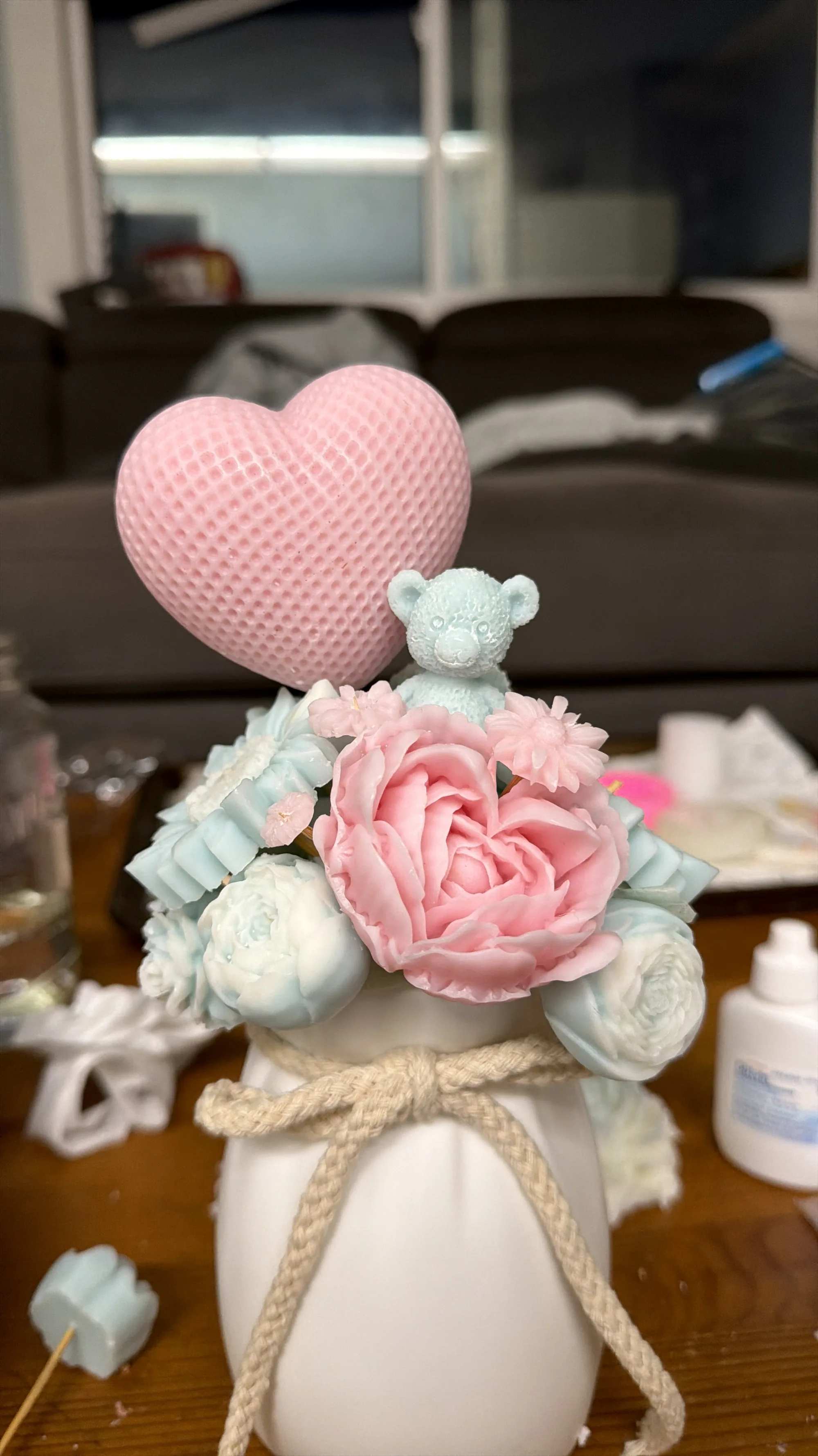 Green and blush candle bouquet in a ceramic vase