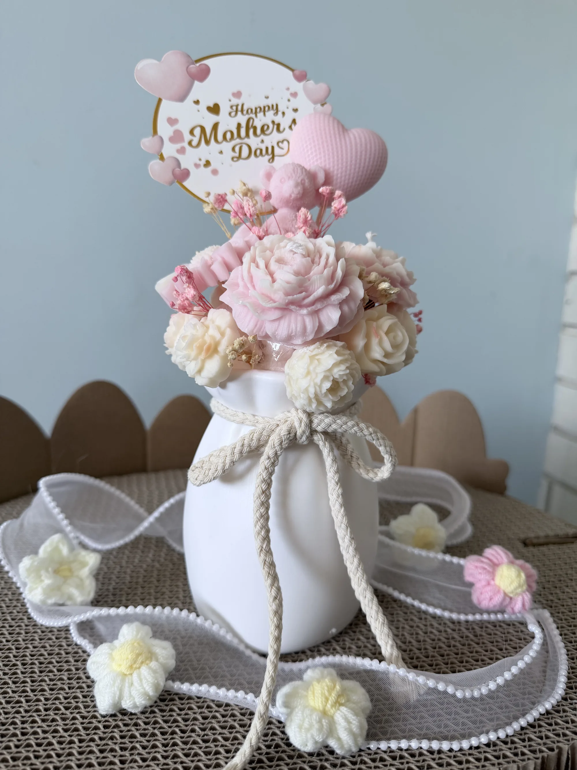 Soft pink floral bouquet in a ceramic vase