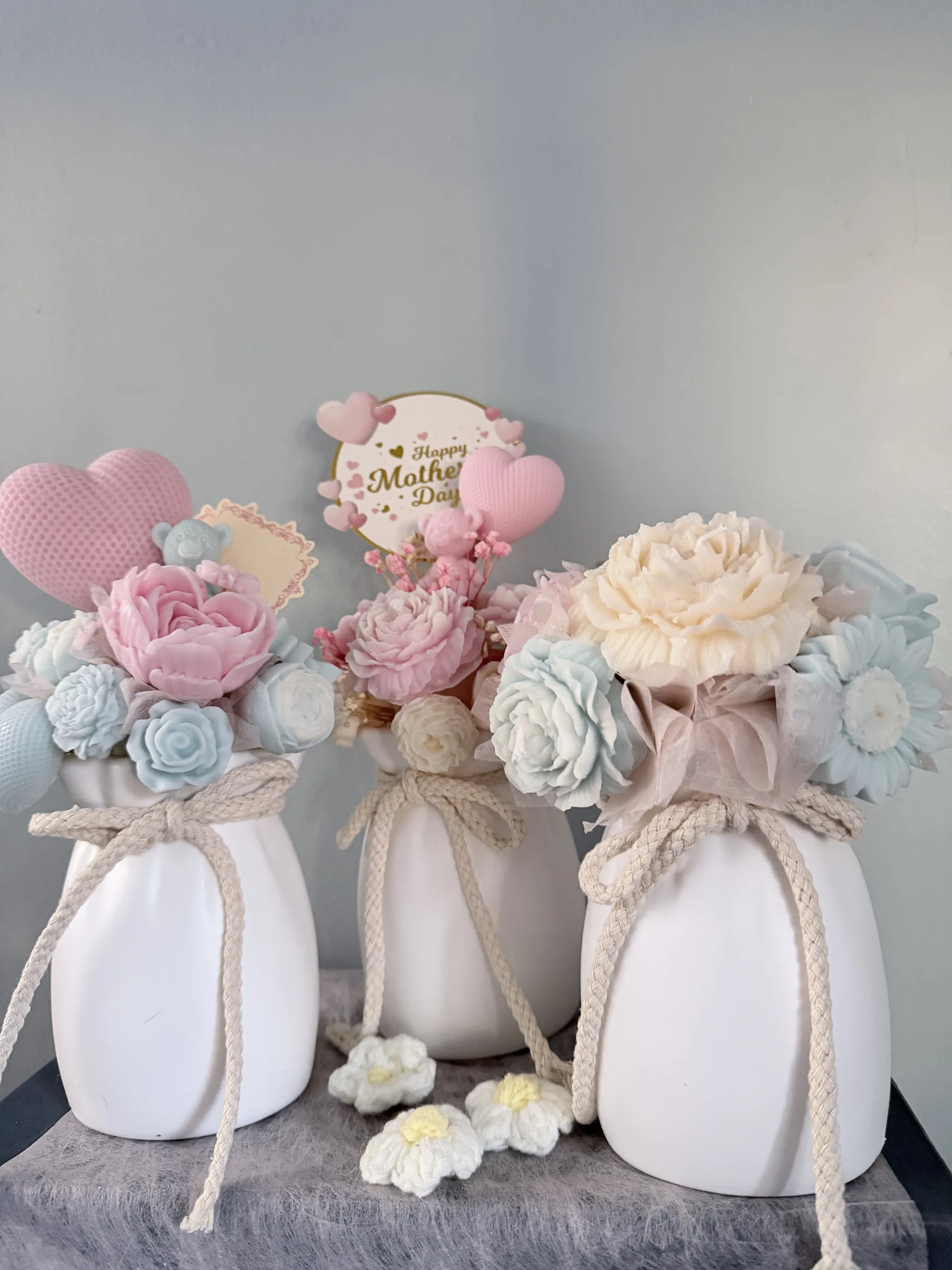 Pair of pastel candle bouquets in matching vases