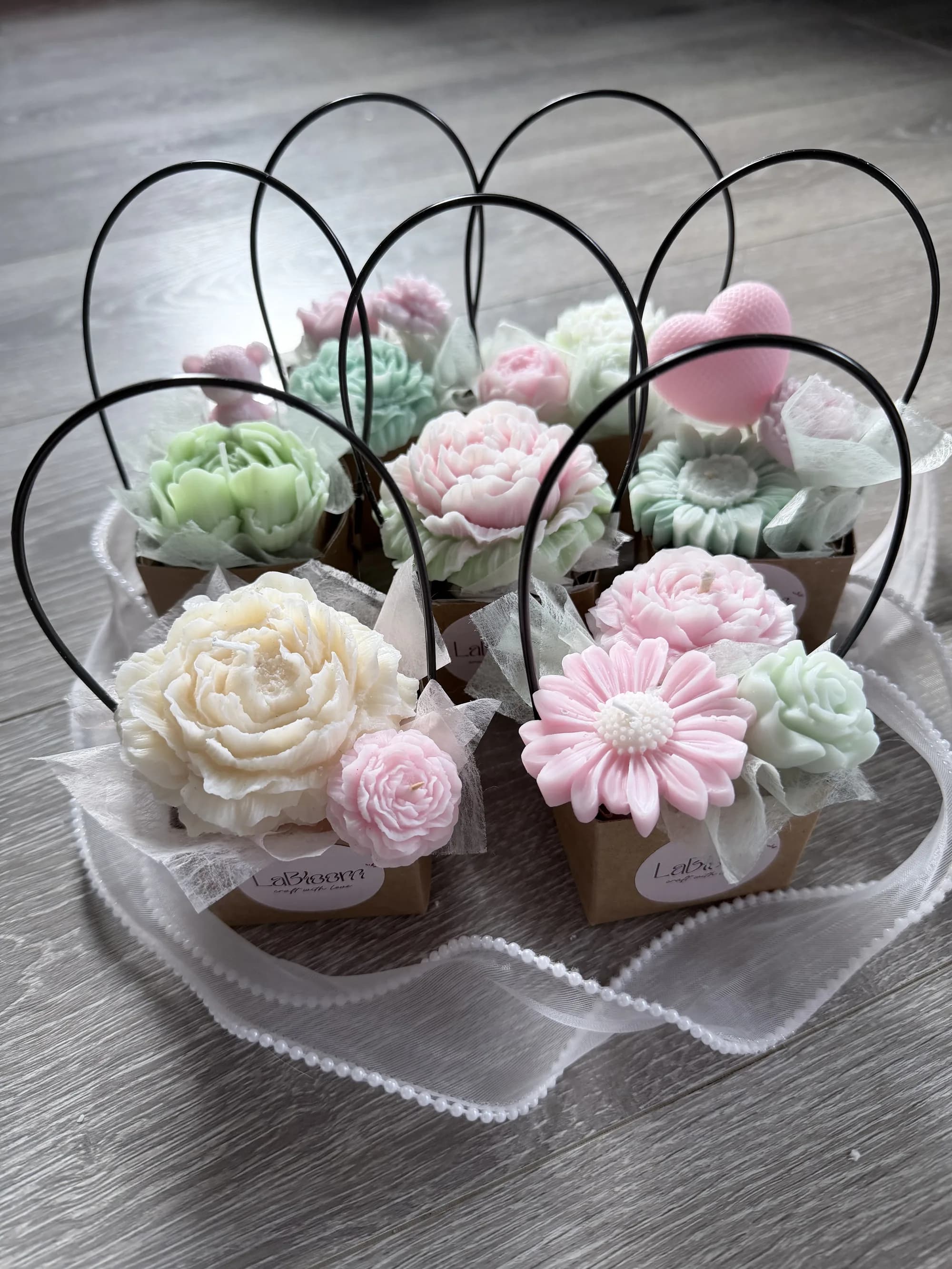 Single floral candle on a soft pastel background